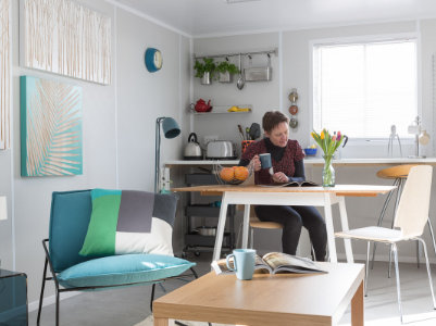 container homes lady sitting at dining table