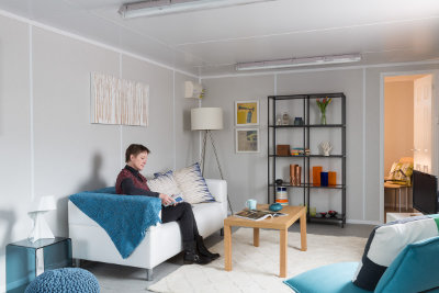 container housing lounge area lady reading a book